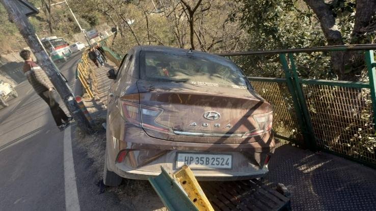 One railing broke, the car got stuck in another railing, driver injured