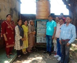 resident of Caiharian presented a water cooler to Tahliyan school