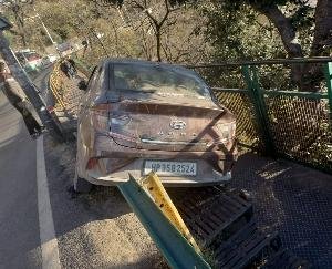 One railing broke, the car got stuck in another railing, driver injured