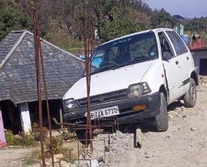 Car hanging on the bridge under construction on Khal Khad in Saleti