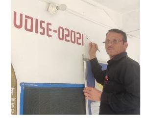 Spokesperson Tilak Raj running brush on the walls of Nandrul School